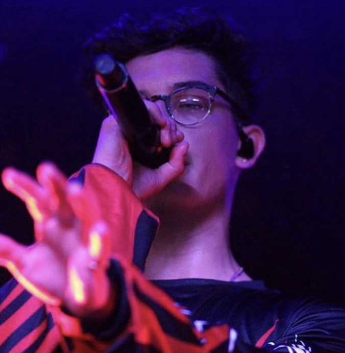 Brandon Arreaga singing with purple overlay 